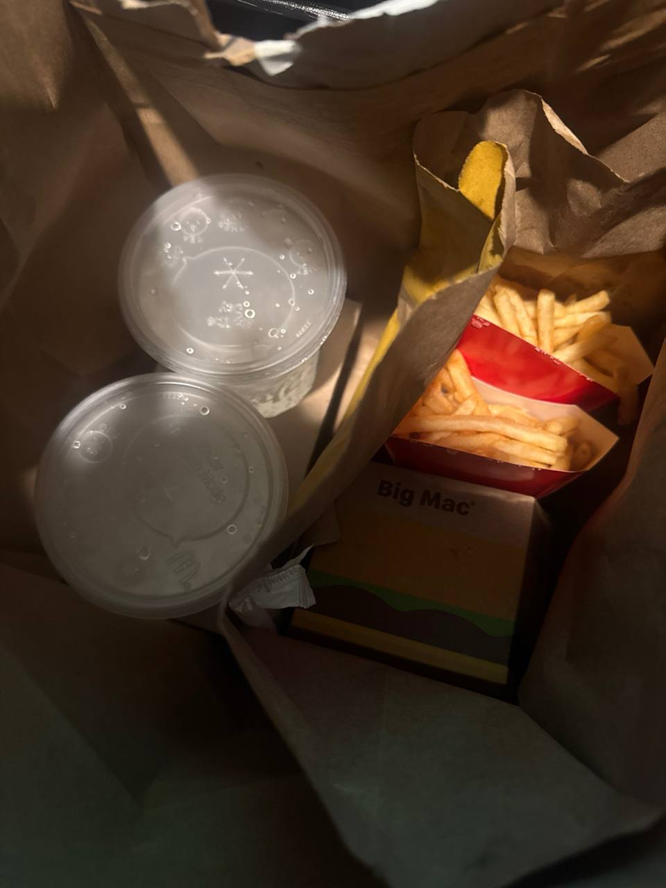 McDonald's bag with Big Mac, fries, and drinks
