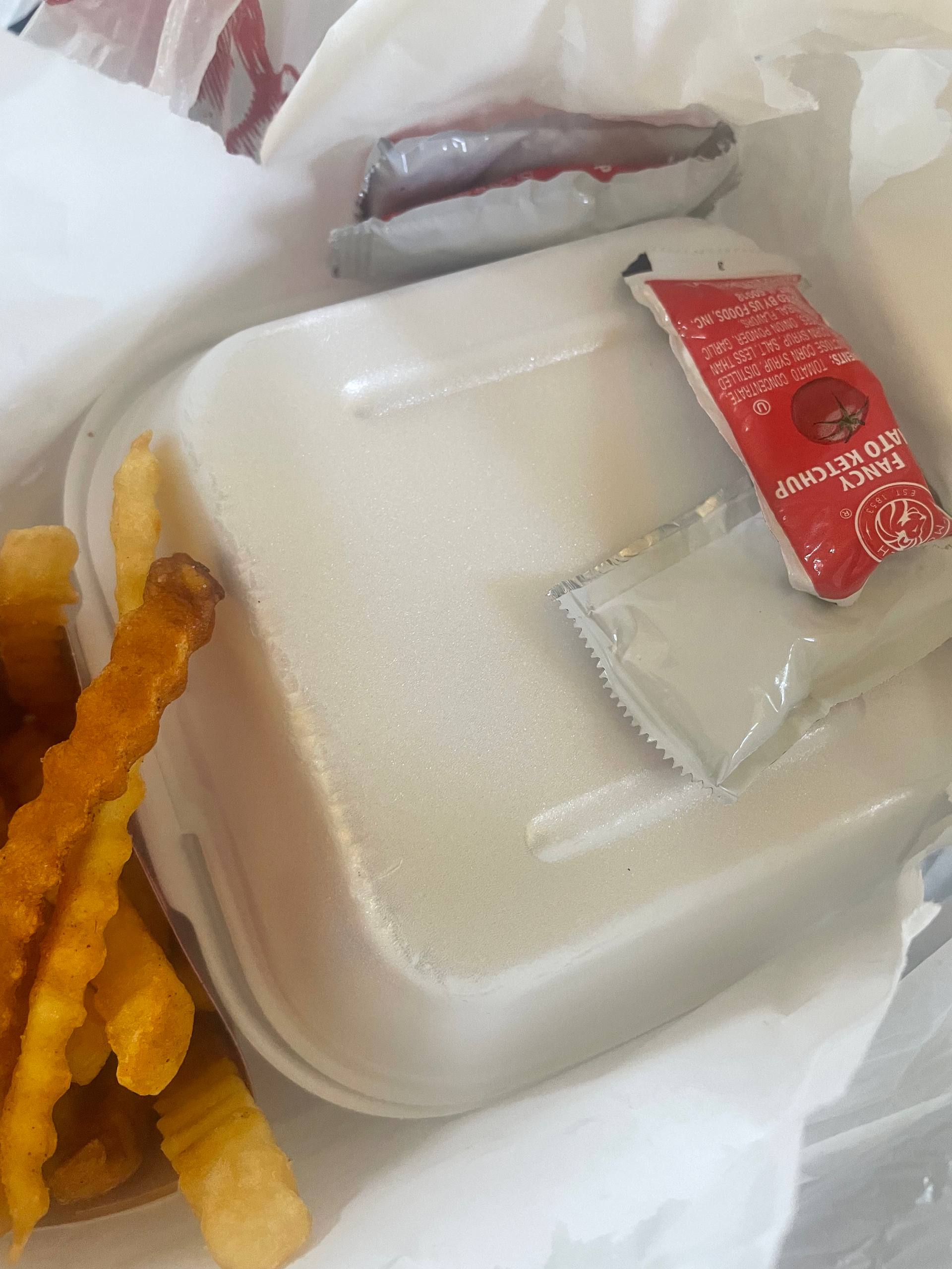 Burger meal with crinkle fries and ketchup