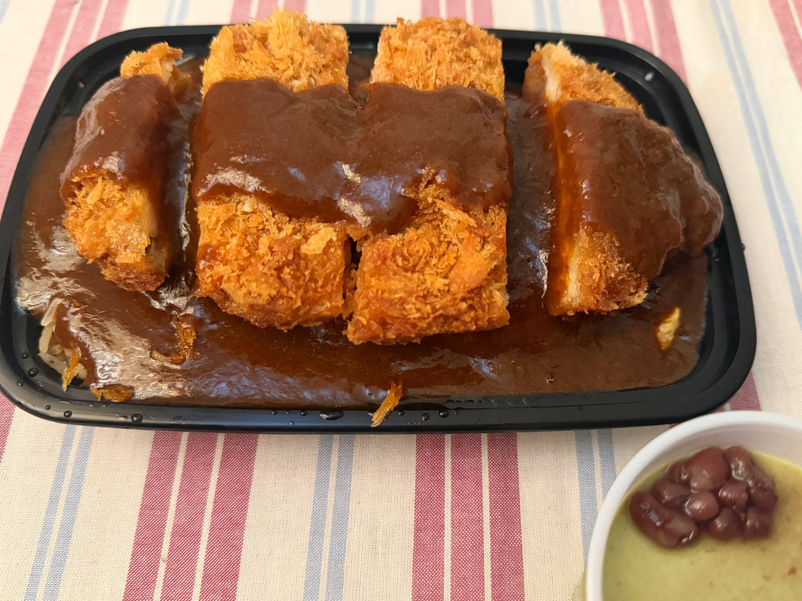 Japanese katsu with sauce in a takeout tray
